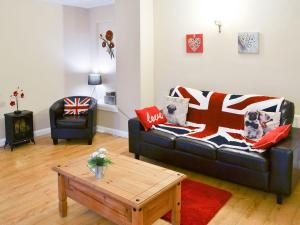 a living room with a couch and a coffee table at Rose Cottage - Uk3283 in Guyzance