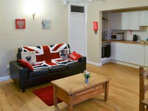 a living room with a couch and a coffee table at Rose Cottage - Uk3283 in Guyzance