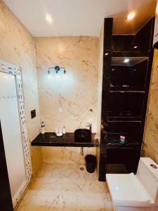 a bathroom with a toilet and a black counter at BLACKVILLA in Mukteswar