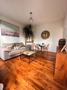 a living room with a couch and a table at Haven of peace at the gates of Paris in Montreuil