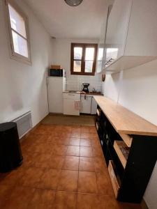 a kitchen with a wooden counter top in a room at Haven of peace at the gates of Paris in Montreuil +3 photos