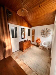 a living room with a wooden ceiling and a door at Haven of peace at the gates of Paris in Montreuil