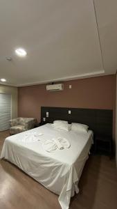 Cama o camas de una habitación en Ônix Inn Hotel Cravinhos