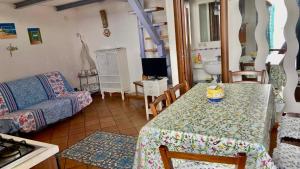 a living room with a table and a couch at Procida Marina Grande in Procida +41 photos