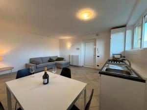 a kitchen with a table with a bottle of wine on it at Casa Karine Swimming Pool and Lake View - Larihome A43 in San Siro