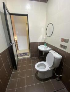 een badkamer met een toilet en een wastafel bij Wan D'Zahra Homestay in Jitra