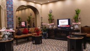 a lobby with a couch and a tv in a room at İpek Palas Otel in Urfa