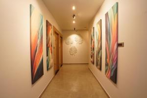 a hallway with many paintings on the walls at Labels Hotel in Nagpur