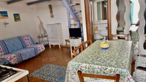 a living room with a table and a couch at Procida Marina Grande in Procida