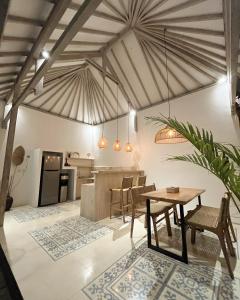 a kitchen and dining room with a table and chairs at Mimpi Villa - Gili Air in Gili Islands +18 photos