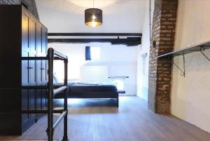 a loft bedroom with a bed and a staircase at sfeervol monumentaal pand in Maastricht