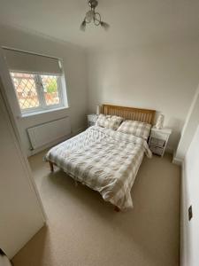 a bedroom with a bed and a window at Lovely modern, well-kept house in Sidcup
