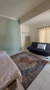 a bedroom with a bed and a rug on the floor at Sea La Vie in Pangandaran