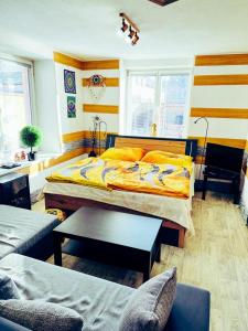 a bedroom with a bed and a table and chairs at Apartmán Pod hradem in Horšovský Týn