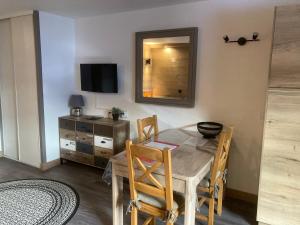 a dining room with a table and a mirror at Appartement Brides Confort in Brides-les-Bains +1 photo