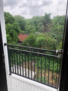 a balcony with a view of a forest at Danja House and Kost in Jimbaran