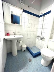 a bathroom with a sink and a toilet at Lovely Sunrise apartment by the beach in Methoni