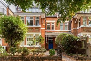 a red brick house with a blue door at The Chiswick Apartments in London