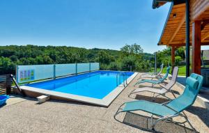 a swimming pool with two chairs at Visija in Sveti Martin na Muri