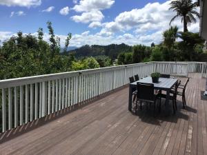a table and chairs on a wooden deck at Serenity Views in Rotorua