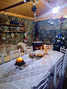 a dining room with a table and a christmas tree at Family Hotel Maia - Cемейная гостиница Майя in Dashbashi