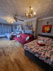 a living room with a bed and a couch at Fox Lodge in Drogheda