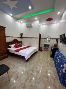 a bedroom with a bed and a tv in it at VILLA GIÓ BIỂN LAGI - Villa Gia đình 4 Phòng Ngủ, Sức chứa 8 - 20 Khách, Cách Biển Cam Bình 700m di chuyển, Sân Vườn Rộng Rãi, Tiện Nghi Nướng BBQ & Bãi Đậu Xe Ô tô Miễn Phí in Lagi +45 photos