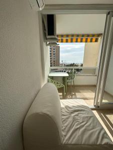 a bedroom with a bed and a view of a balcony at Tamarindo 5 in Benalmádena