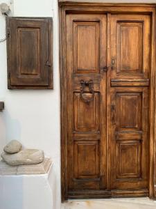 an old wooden door in a white room with at Traditional apartment in the heart of Mykonos! in Mikonos