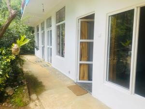 an empty hallway of a house with a door at Hugging Clouds in Adams Peak