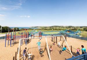 a group of people playing in a playground at 51 Oaklands thorness bay Parkdean holiday resort in Cowes