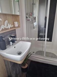 a bathroom with a sink and a shower at Sienna's littlesea getaway in Wyke Regis