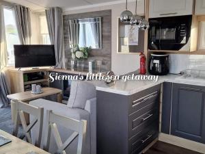 a kitchen with a couch and a table in a room at Sienna's littlesea getaway in Wyke Regis