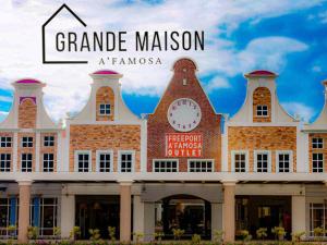 a large building with a clock on top of it at Grande Maison Homestay A'Famosa Golf view Near WATERPARK l UITM l HONDA l Netflix l self check in in Kampong Alor Gajah