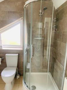 a bathroom with a toilet and a glass shower at Pass the Keys Stunning townhouse in uphill historic Lincoln in Lincoln