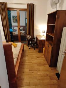 a hotel room with a bed and a desk and a desk at Apartmán Jezerska in Subotica +4 photos