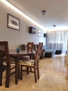 a living room with a table and chairs and a couch at Parque De Las Naciones Dragon con garaje ! in Torrevieja