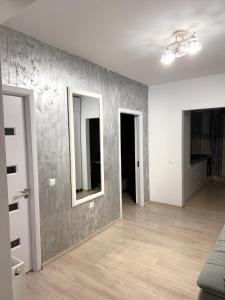 an empty room with a wall with a mirror at Apartament Craiova Magnolia in Craiova