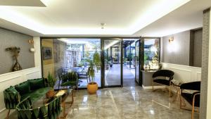 a room with a table and chairs and a hallway at Mai İnci Otel in Antalya