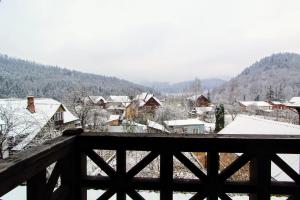 a snow covered town with houses and buildings at Бесаги in Yaremche