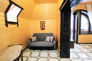 a room with a chair in a room with wooden walls at Бесаги in Yaremche