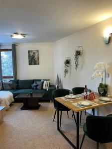 a living room with a couch and a table at Elizi winter apartments Pamporovo in Pamporovo