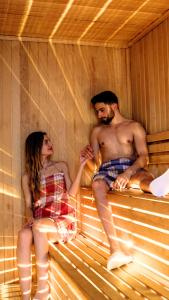 a man and a woman sitting in a sauna at Mai İnci Otel in Antalya