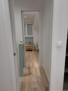 a hallway leading to a room with a table at MAISON INDEPENDANTE in Revin