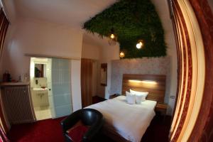 a hotel room with a bed and a mirror at Hotel Almrausch in Bad Reichenhall