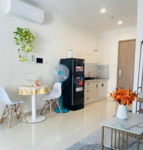 a kitchen with a small table and a black refrigerator at Căn hộ studio Vinhomes Grand Park, Thủ Đức city, Hồ Chí Minh city in Long Bình