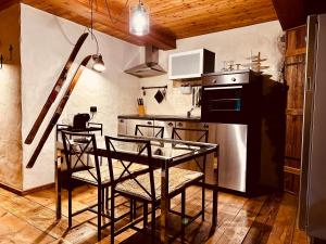 a kitchen with a glass table and some chairs at Maison Bovet Mont Blanc in La Salle