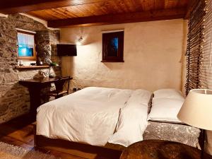 a bedroom with a bed and a table and a window at Maison Bovet Mont Blanc in La Salle +10 photos