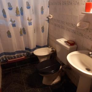 a bathroom with a toilet and a sink at CASA CONFORT in Corralitos