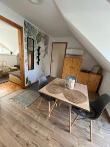 a dining room with a table and chairs at Luca Vendégház in Sárvár